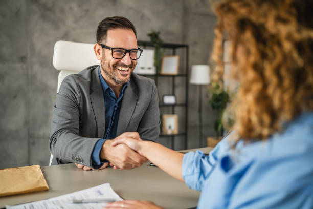 istock colleagues handshake after successful project in the office 2184073039