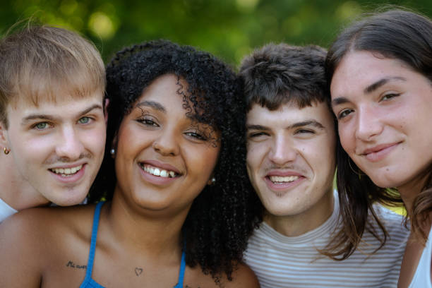 istock Four young students smiling together outdoors: 2184073111