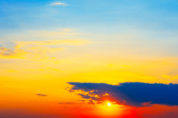 Warm hues across the sky and landscape. Sunset sky painted in shades of orange and pink