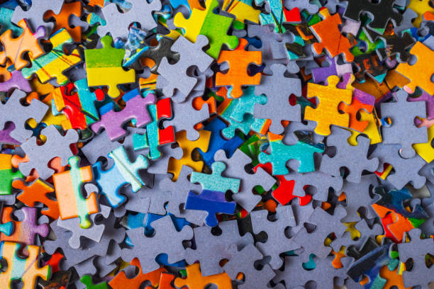 istock Top view many jigsaw puzzle pieces over the entire frame 2184073870