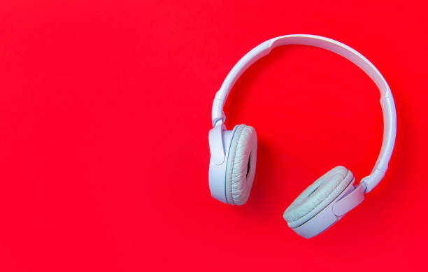 istock White wireless headphones on a bright red background. copy space 2184074012