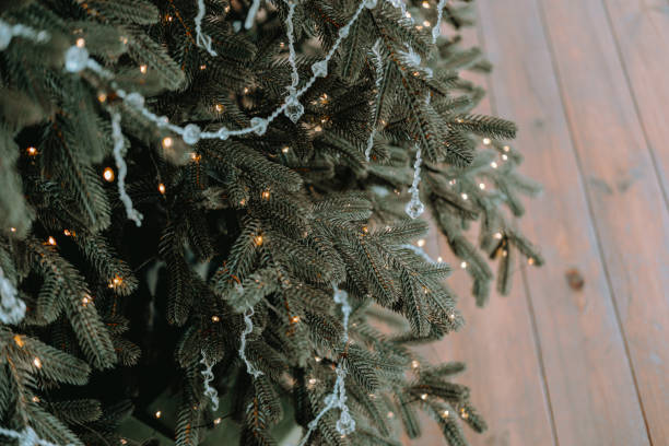 istock Beautifully decorated Christmas tree with lights and ornaments in cozy setting 2184074624