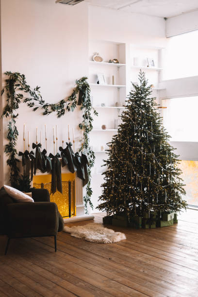 istock Cozy Christmas scene with a tree and stockings by the fire 2184074649