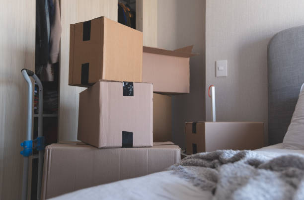 istock A room with a bed and a stack of boxes. New home concept. 2184074770