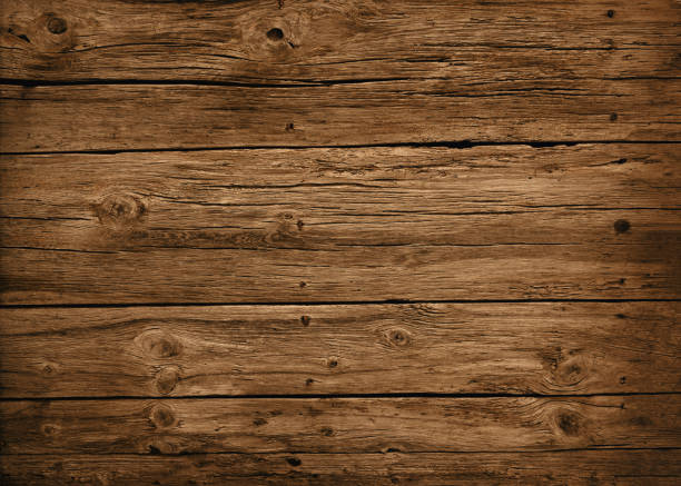 Old brown wood texture in a rustic style Background of an aged brown wood texture with a natural, rustic style. barn stock pictures, royalty-free photos & images