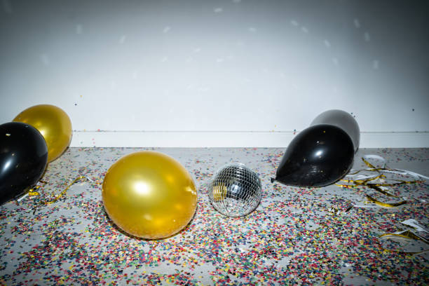 istock Black and gold balloons scattered on the floor 2184076396
