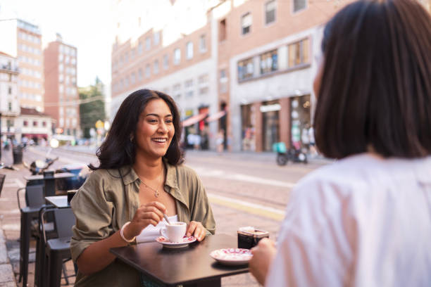 istock Two friends enjoying coffee outdoors in Milano, Italy 2184076443