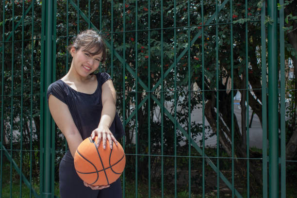 istock Young woman modeling with a basketball 2184078446