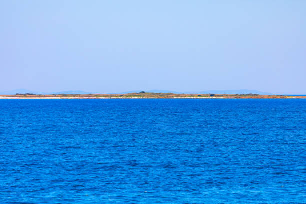 Serene island surrounded by vast ocean waters. Picturesque island located in blue sea