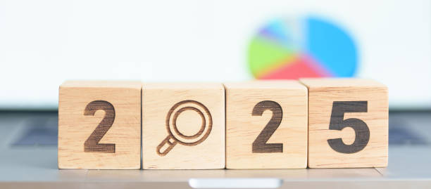 istock 2025 Year block with magnifying glass icon against laptop computer. SEO, Search Engine Optimization, hiring , Advertising, Idea, Strategy, marketing, Keyword, Content and New Year start concepts 2184082067