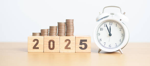 istock Happy New Year 2025 with clock and coins stack arrangement. Money Saving for Future Plan, Retirement fund, Pension, Investment, Wealth Business, Financial and countdown concepts 2184082623