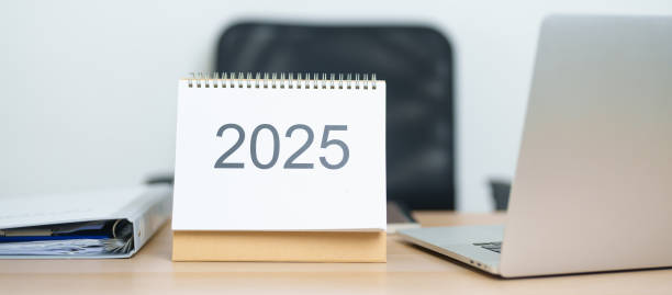 istock 2025 Year Calendar on table with laptop computer during working and writing in office. countdown, Happy New Year, Resolution, Year End and New Start and Goals Plan Action Concept 2184082719