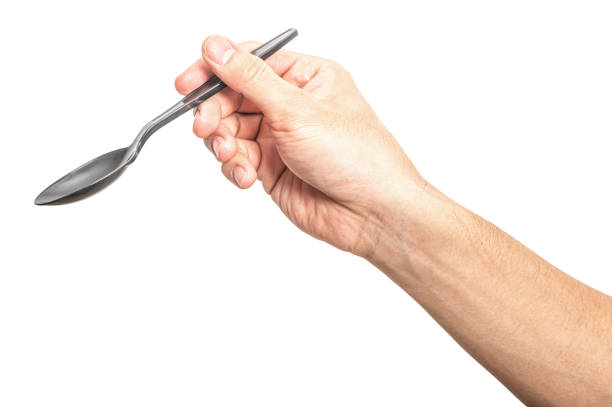 istock Male hand holding a black plastic spoon isolated on white background. 2184083474