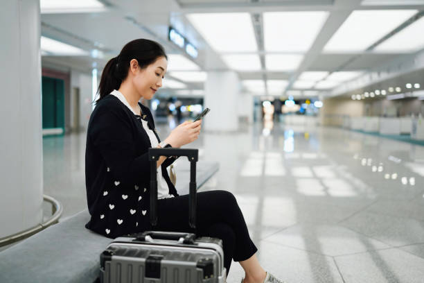 istock A Young Woman Relaxing at the Airport While Using Her Smartphone 2184087941