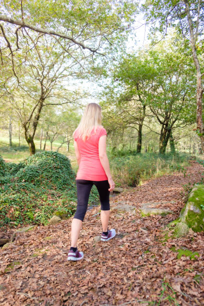 istock woman walking in the forest 2184088839