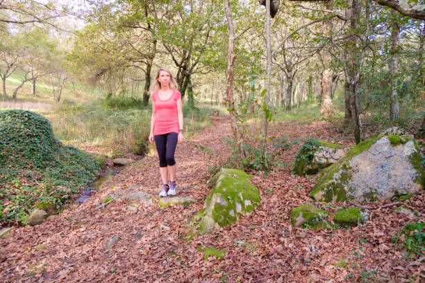 istock woman walking in the forest 2184089456