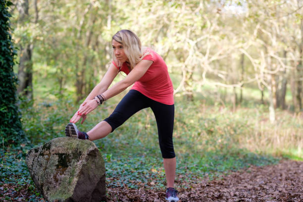 istock woman exercising in the forest 2184089660