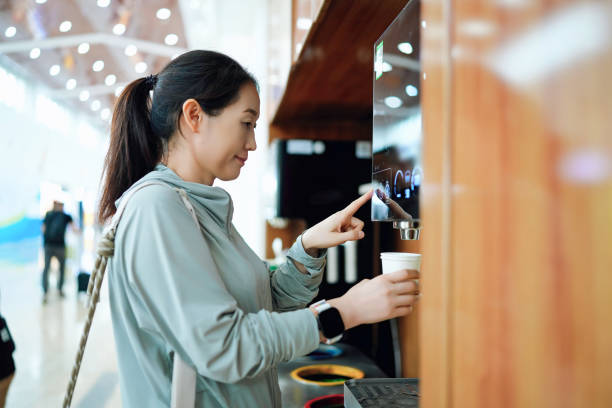 istock Modern Convenience: A Woman Enjoying Automated Coffee Service 2184089754