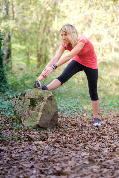 istock woman exercising in the forest 2184090134