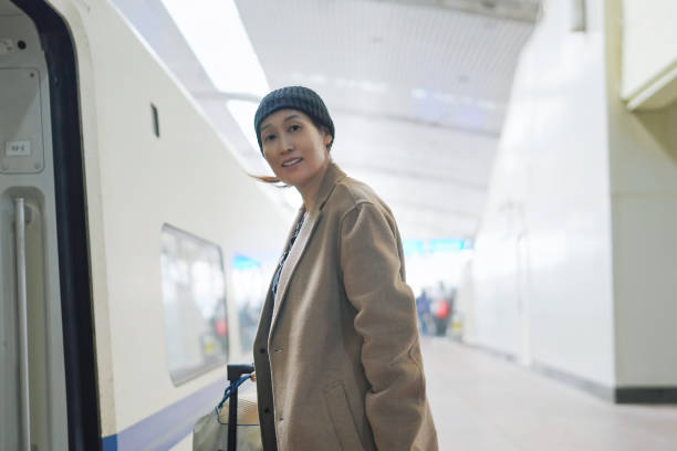 istock Stylish Traveler Boarding a Train at Modern Station 2184090195