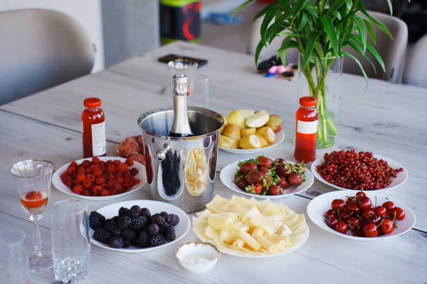 A served banquet table with fruits, drinks and a camera. A simple menu for a bachelorette party.