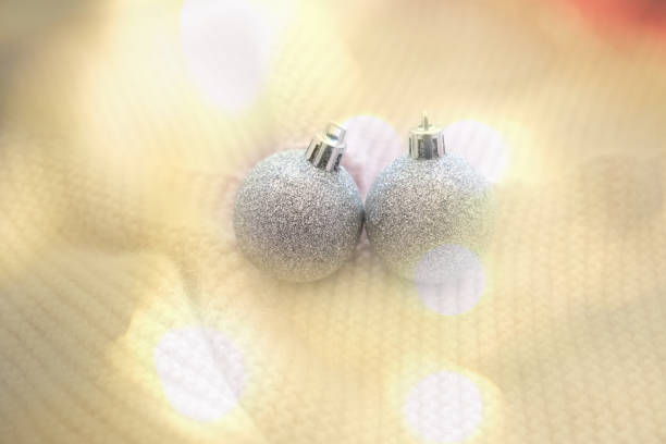 Christmas decorations, silver balls, baubles on white soft background. Lightweight. Atmospheric mood. Merry Christmas and Happy New Year.  copy space, place for text