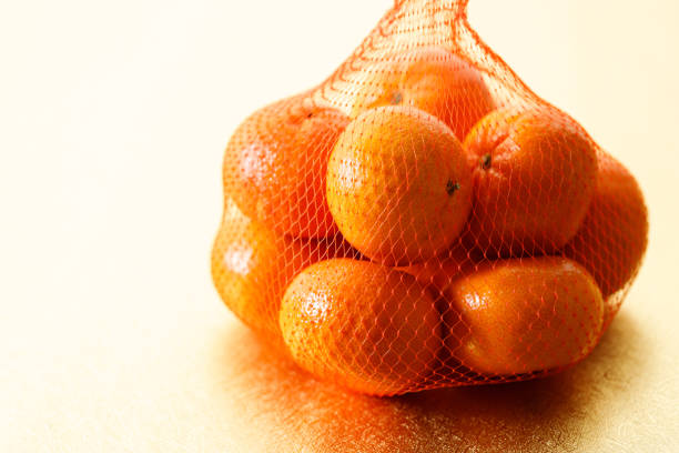 istock Tangerine oranges on golden background for celebration Lunar New Year 2184101963