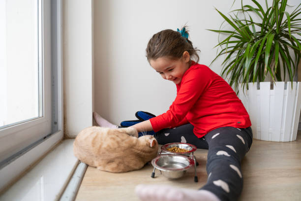 Heartwarming interactions between children and their pets, showing the responsibilities, compassion and learning experiences involved in pet care. Mutual love and trust between children and their furry friends. Pet feeding, grooming, bonding moments.