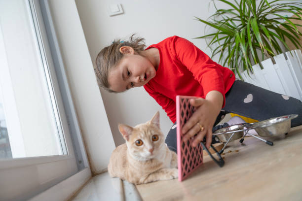 istock Heartwarming interactions between children and their pets, showing the responsibilities, compassion and learning experiences involved in pet care. Mutual love and trust between children and their furry friends. Pet feeding, grooming, bonding moments. 2184103157
