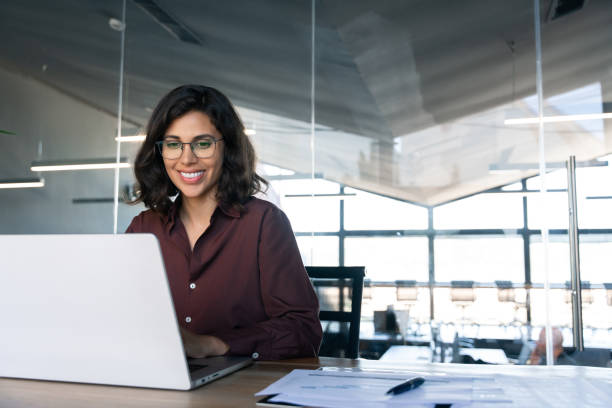 istock Smiling young middle eastern business woman specialist working focused on laptop computer. Middle aged latin hispanic investor, bank worker using pc for analysing, network at workplace desk in office 2184105560