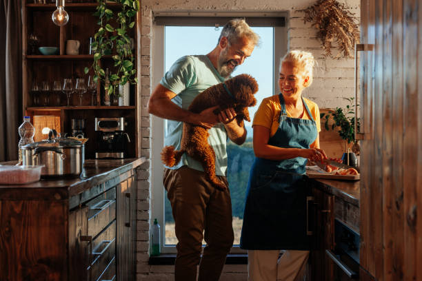 istock Senior couple in kitchen with dog. 2184106259