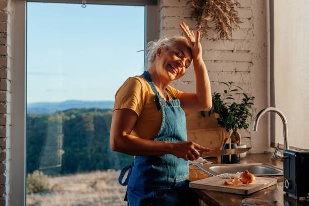 istock Woman cutting onions at home. 2184106268