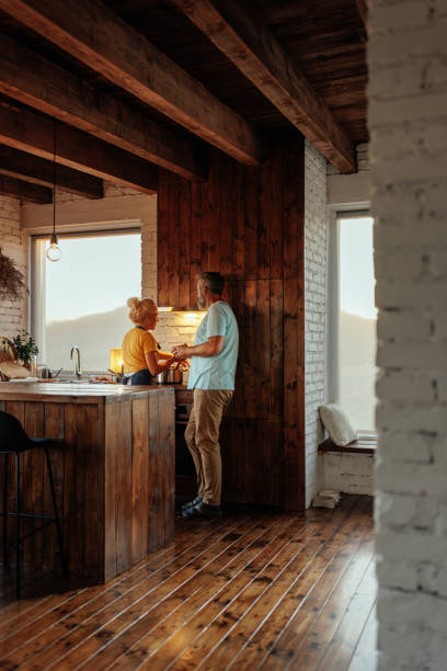 istock Retired couple cooking together in kitchen. 2184106278