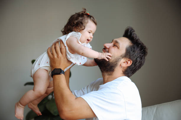 istock Young father holding her baby girl 2184106352