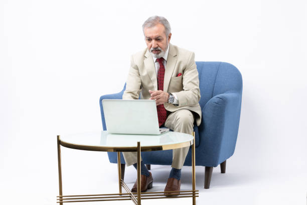 istock Senior man using laptop studio shoot stock photo 2184108025