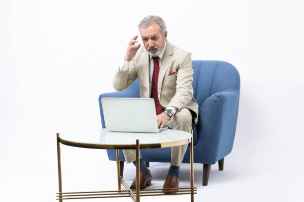 istock Senior man using laptop studio shoot stock photo 2184108064