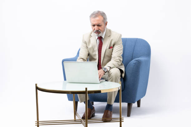 istock Senior man using laptop studio shoot stock photo 2184108308