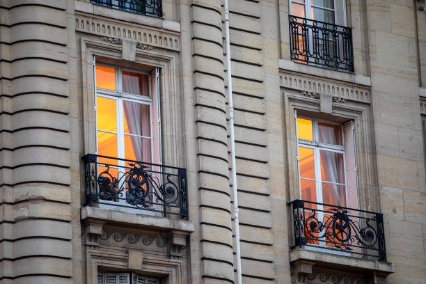 Lights on in the windows of a traditional Parisienne apartment building