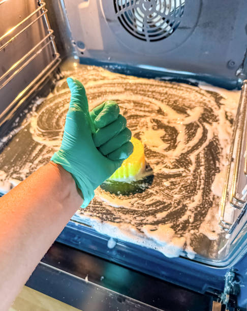 istock Thumbs Up for Clean, Oven Scrubbing with Soap and Gloves in Progress 2184108988