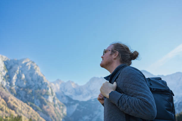 istock Young man walks down road in mountains 2184110472
