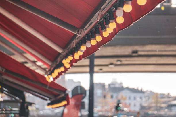 istock Bright lights hang under a restaurant's awning 2184110815