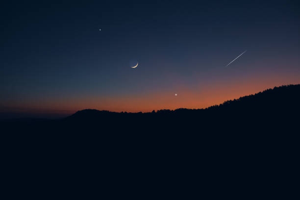 istock Countryside silhouettes under the stars, meteor trail and crescent Moon. 2184111473