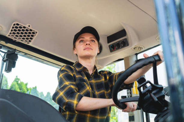 istock Low-angle portrait of confident female farm working operating tractor. 2184113456