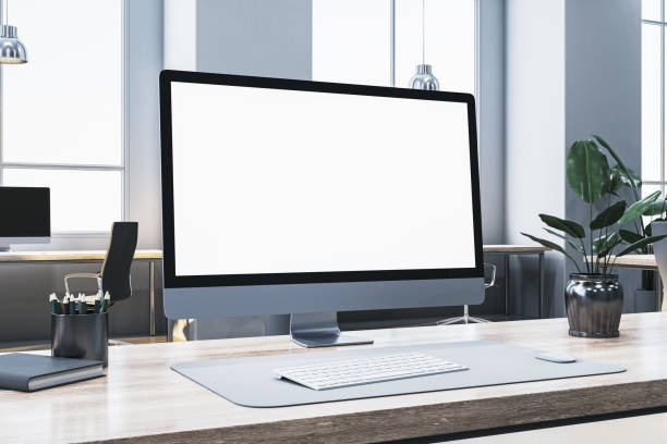 istock Modern computer screen with blank display on an office desk, clean workspace, and plants in a well-lit room. 3D Rendering 2184114047