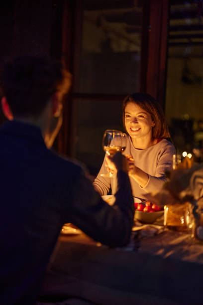 istock Happy woman toasting with her husband during dinner date night. 2184114078
