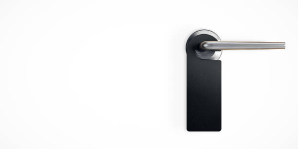 istock Black door hanger tag hanging on a metal handle over white background, isolated on white wall with modern minimal design. 3D Rendering 2184114145