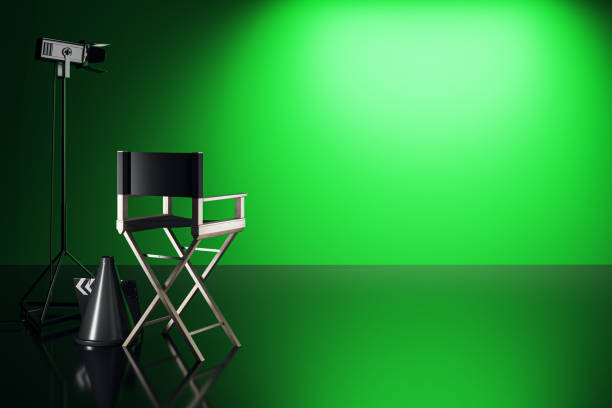 istock Director's chair and spotlight in film studio with green screen background. 3D Rendering 2184114235