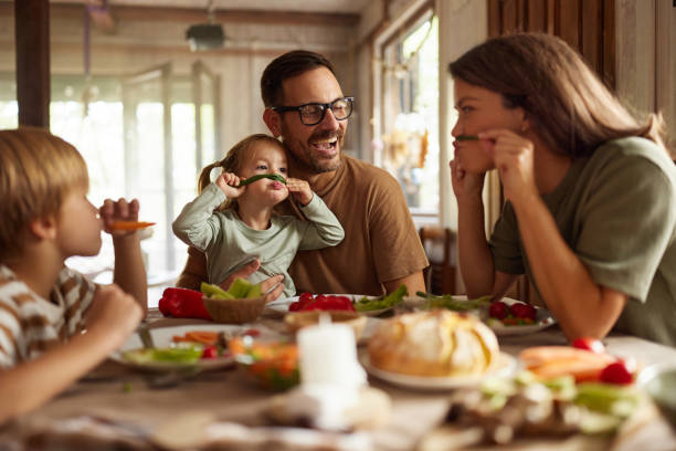 Playful family having fun during a meal at dining table.