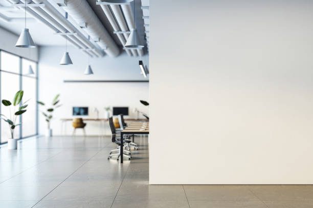 istock Modern office interior with desks, chairs, computers, and plants, minimalist design, focus on light and space, city view windows. 3D Rendering 2184114457
