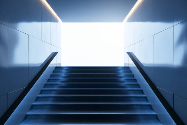 istock Stairs leading upwards in a subway setting with a bright light at the top. 3D Rendering 2184114563